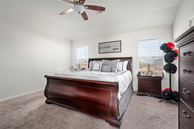 bedroom with light carpet, ceiling fan, visible vents, and baseboards