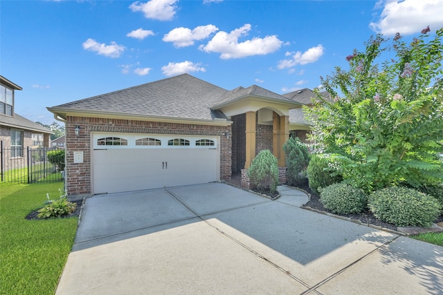 view of front of home featuring a garage and a front lawn