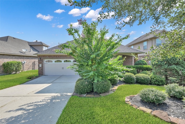 view of front of home with a garage and a front lawn