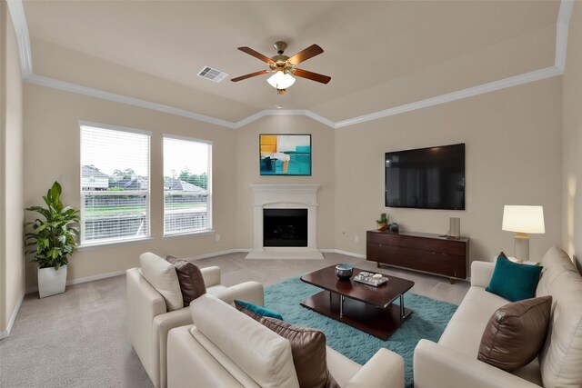 carpeted spare room featuring vaulted ceiling, ceiling fan, and crown molding