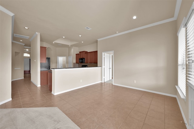 kitchen featuring kitchen peninsula, black appliances, light tile patterned floors, and crown molding