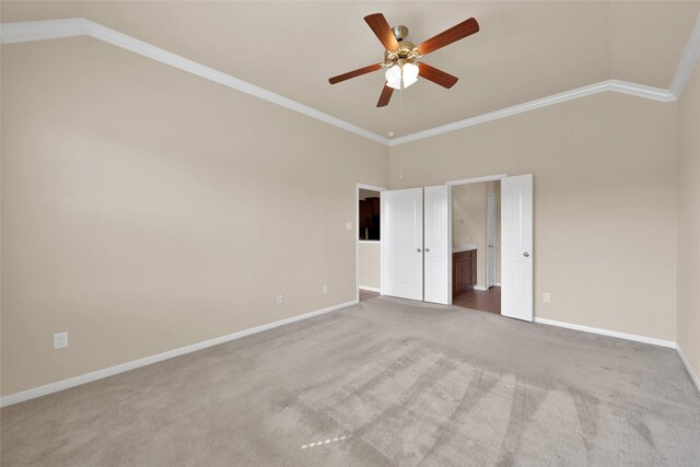 unfurnished bedroom with ornamental molding, carpet, ceiling fan, and high vaulted ceiling