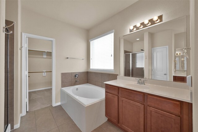 bathroom featuring vanity, independent shower and bath, and tile patterned flooring