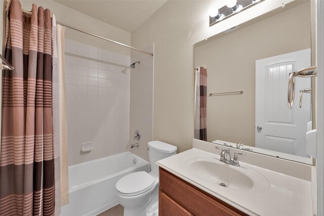 full bathroom with shower / tub combo with curtain, vanity, and toilet