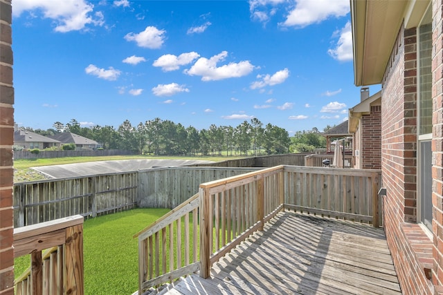 wooden terrace with a lawn