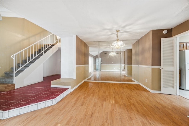 interior space with a notable chandelier and hardwood / wood-style flooring