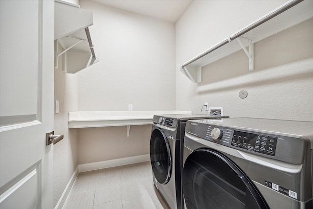 laundry area with washing machine and clothes dryer