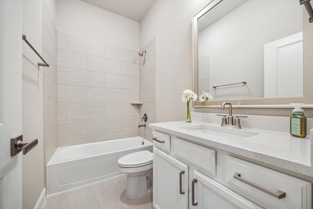 full bathroom featuring toilet, tiled shower / bath combo, vanity, and tile patterned flooring