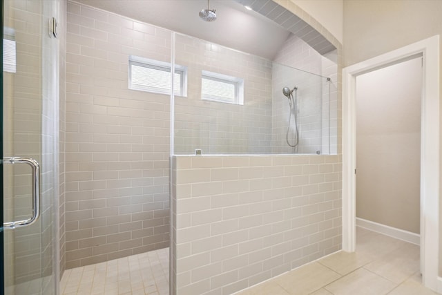 bathroom with an enclosed shower and tile patterned floors