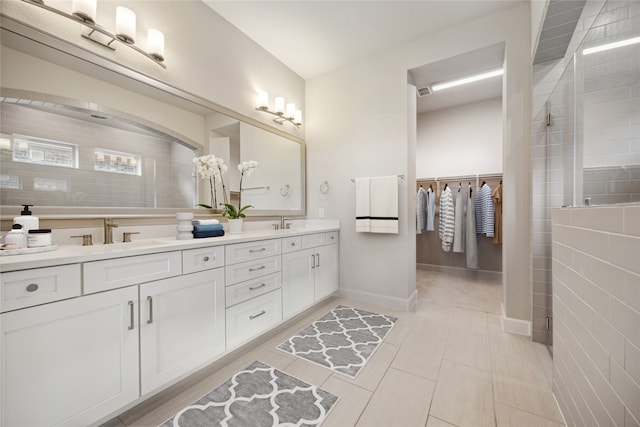 bathroom featuring walk in shower, tile patterned flooring, and vanity