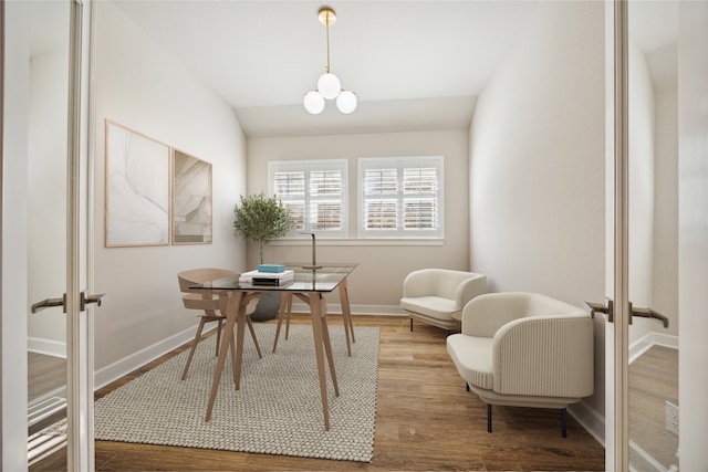 office area with vaulted ceiling, a notable chandelier, french doors, and wood-type flooring