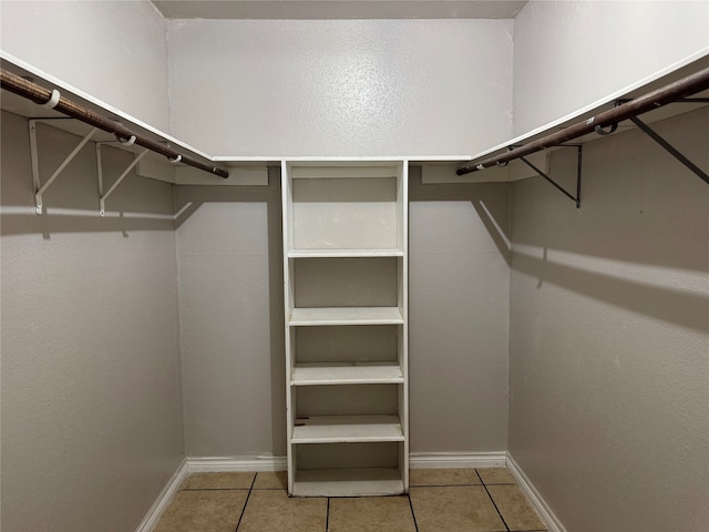 spacious closet featuring light tile patterned flooring