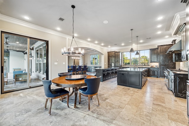 dining room with a chandelier and crown molding