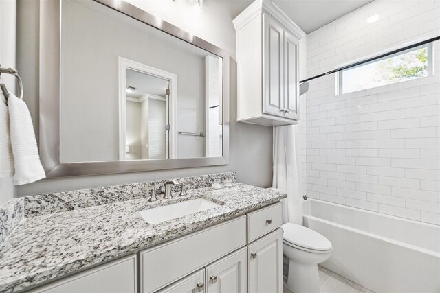 full bathroom featuring shower / tub combo with curtain, vanity, and toilet