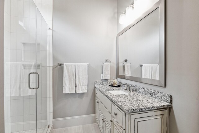 bathroom featuring vanity and a shower with shower door