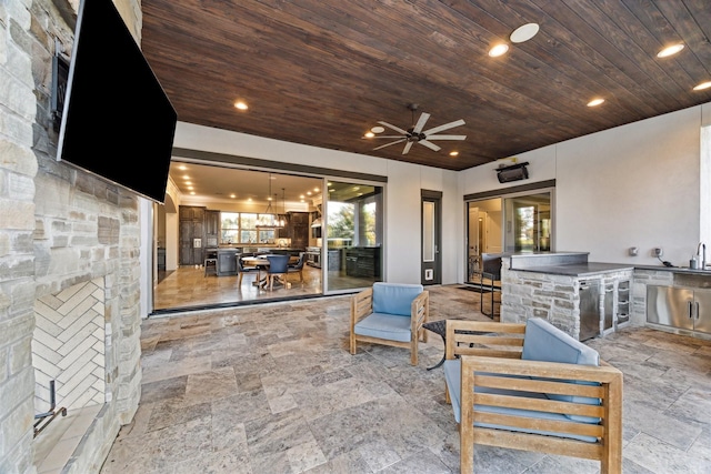 view of patio / terrace with an outdoor living space, a ceiling fan, and area for grilling