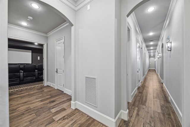 hallway with dark wood-type flooring and ornamental molding