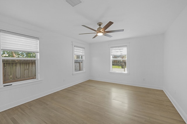 empty room with ceiling fan and light wood-type flooring