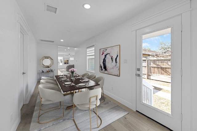 dining space with light hardwood / wood-style flooring and plenty of natural light