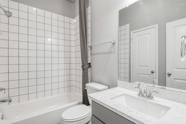 full bathroom featuring vanity, toilet, and tiled shower / bath