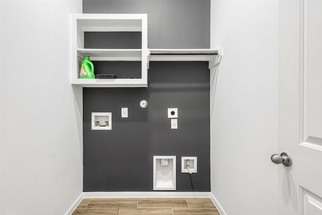 laundry area with electric dryer hookup, gas dryer hookup, light hardwood / wood-style flooring, and washer hookup