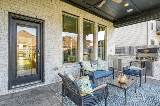 view of patio / terrace featuring an outdoor hangout area, area for grilling, and an outdoor kitchen