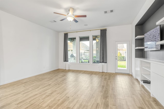 unfurnished living room with ceiling fan and light wood-type flooring