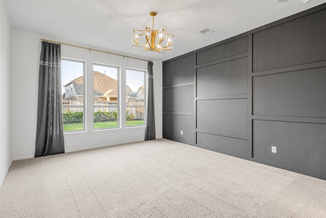 interior space featuring a notable chandelier and light carpet