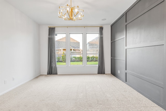 spare room featuring light carpet, a mountain view, and a notable chandelier