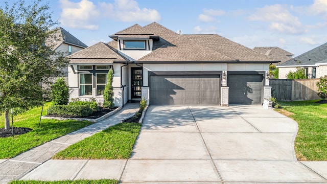 view of front of home with a front yard and a garage