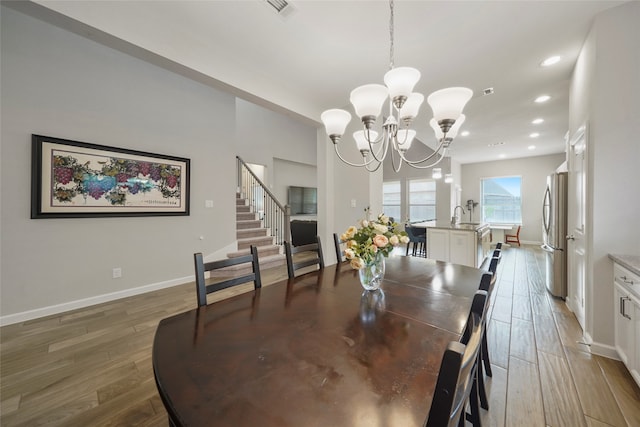 dining room featuring an inviting chandelier and dark wood-type flooring