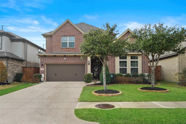 view of front facade featuring a front yard and a garage