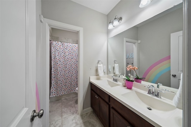 bathroom featuring a shower with shower curtain, tile patterned floors, vanity, and toilet