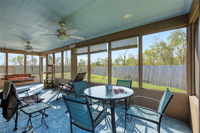 sunroom / solarium with ceiling fan and a healthy amount of sunlight