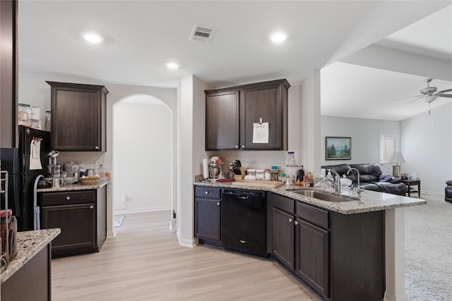 kitchen featuring dishwasher, dark brown cabinets, light hardwood / wood-style flooring, and sink