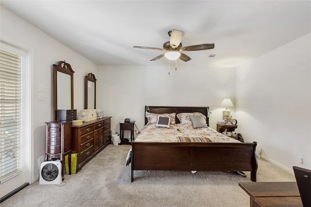 bedroom with ceiling fan and light carpet