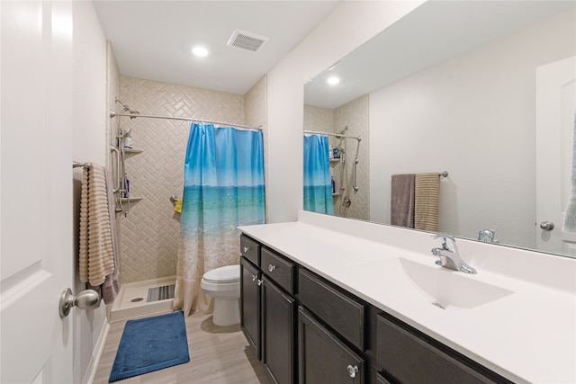 bathroom featuring vanity, toilet, wood-type flooring, and walk in shower