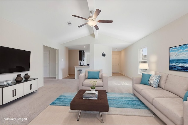 living room with light carpet, vaulted ceiling with beams, and ceiling fan