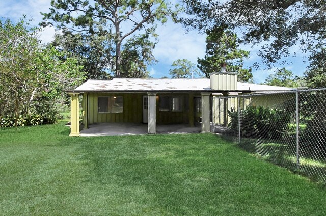 back of house featuring a yard and a patio