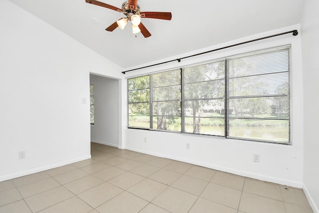 tiled empty room featuring ceiling fan and vaulted ceiling