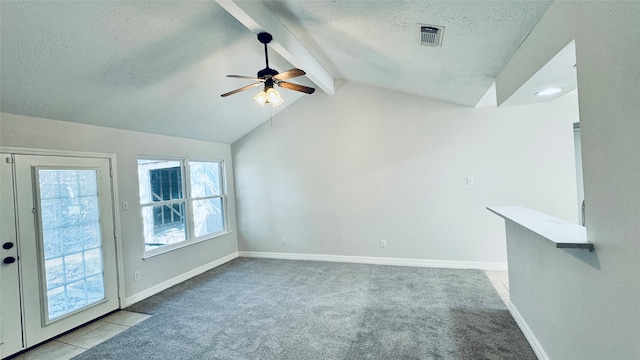 unfurnished living room with light carpet, a textured ceiling, vaulted ceiling with beams, and ceiling fan