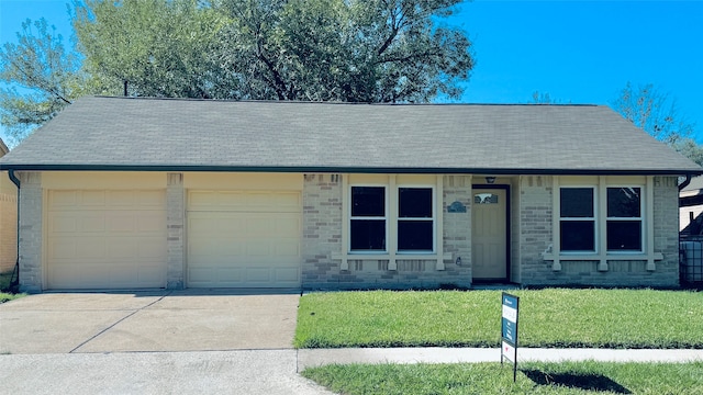 single story home featuring a garage and a front yard