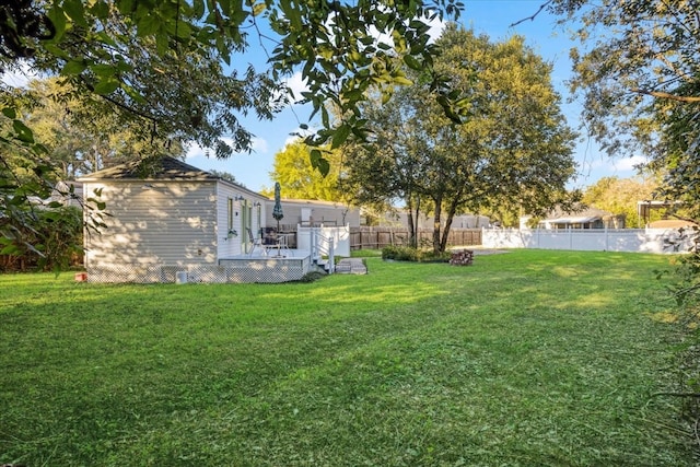 view of yard with a wooden deck