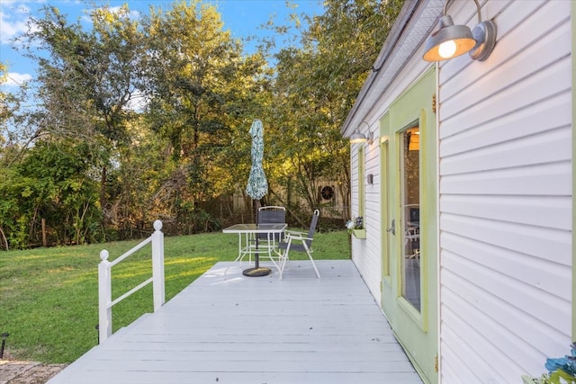 wooden terrace with a lawn