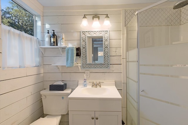 bathroom featuring vanity, an enclosed shower, and toilet