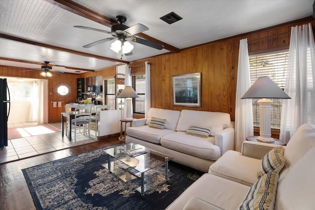 living room featuring hardwood / wood-style floors, beamed ceiling, and plenty of natural light