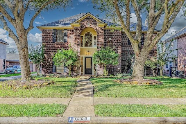 view of front of home with central AC and a front lawn