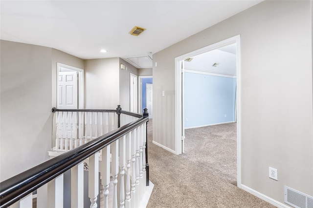 hallway featuring light colored carpet