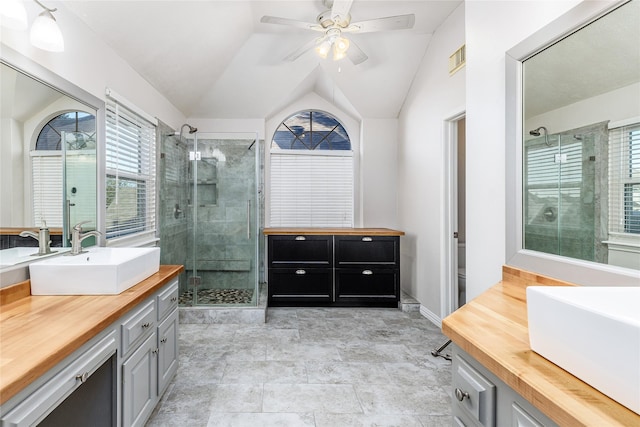 bathroom featuring toilet, an enclosed shower, vaulted ceiling, vanity, and ceiling fan