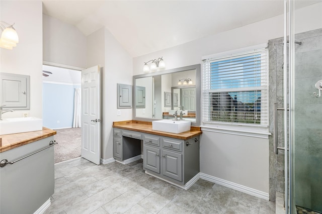 bathroom with vanity, an enclosed shower, and vaulted ceiling